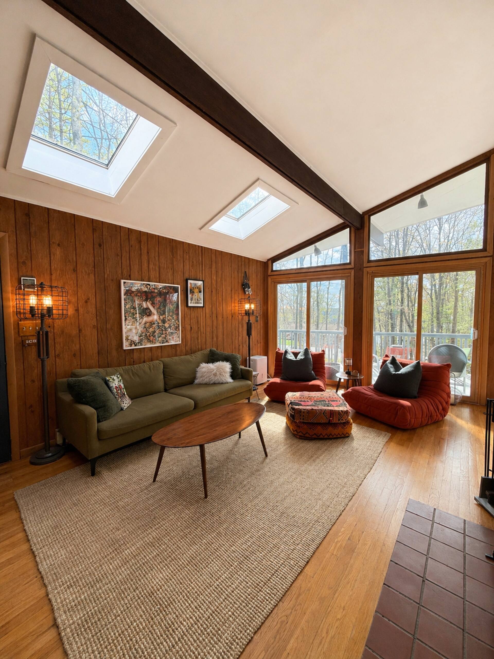 Vaulted living room with skylights and mid-century furniture